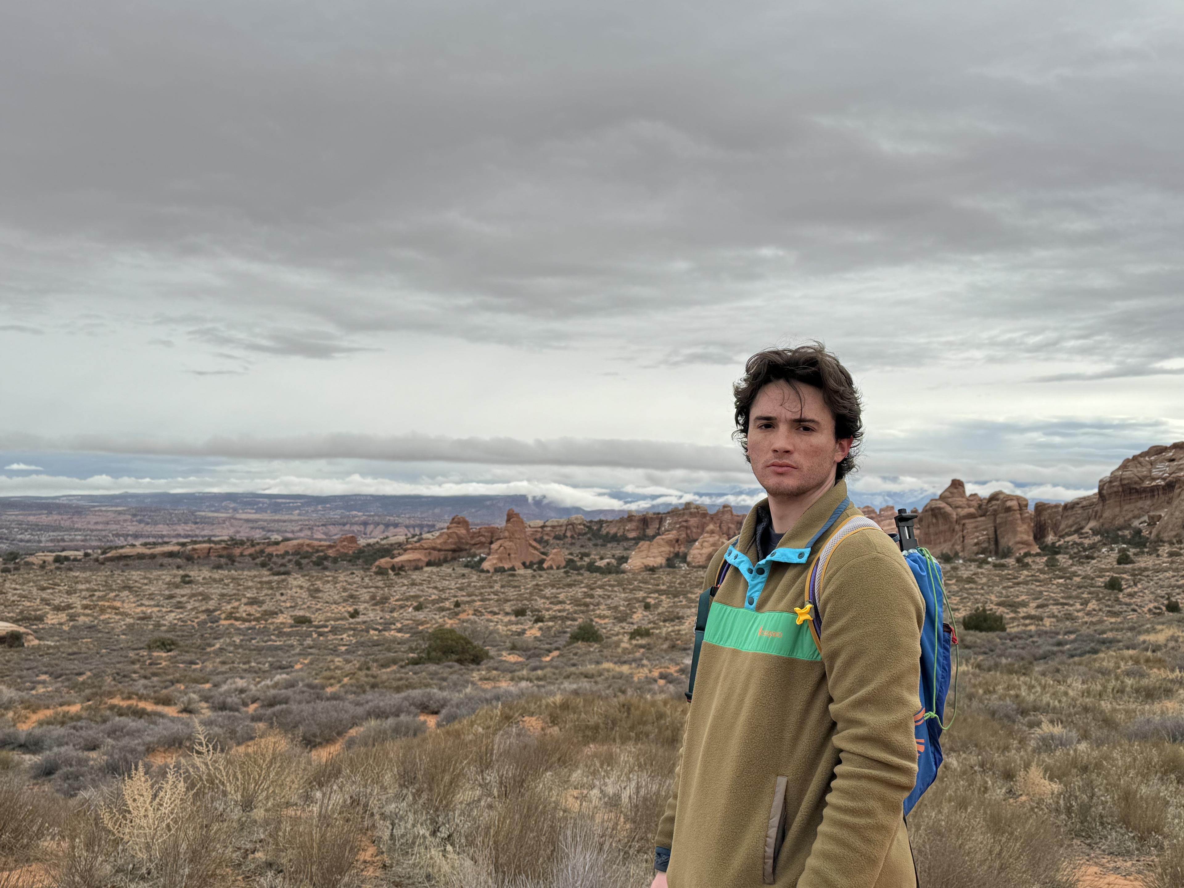 Cooper in the Utah desert with a wide cinematic landscape behind him